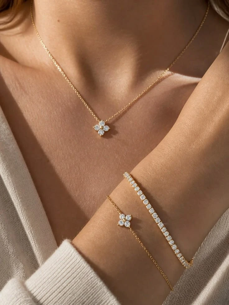 A clover lab-grown diamond pendant, matching clover bracelet and a slim tennis bracelet in yellow gold