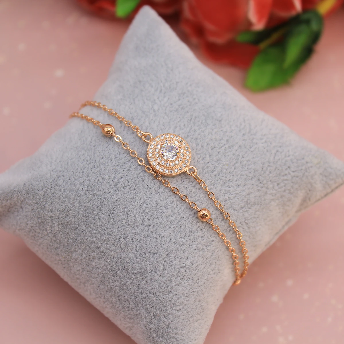 Diamond jewelry arranged in a gift box on a cream backdrop