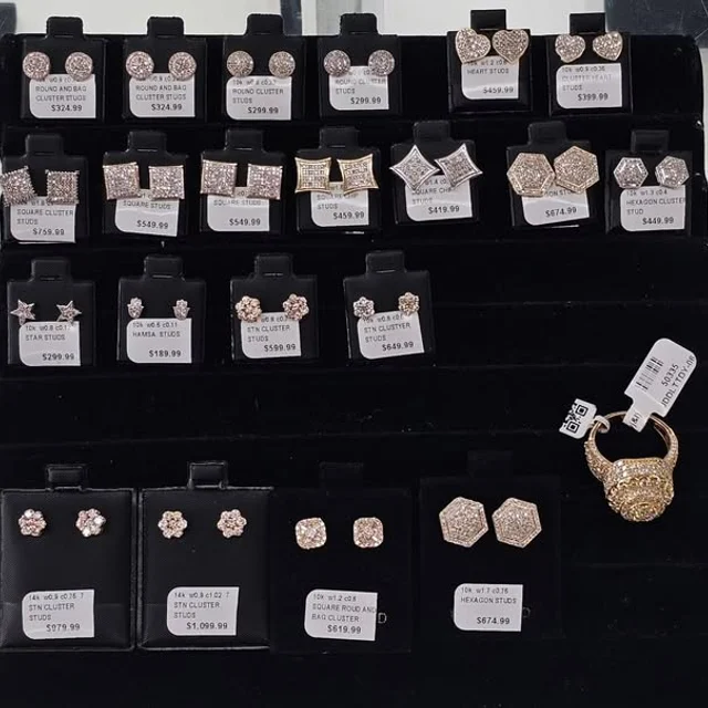 Rows of diamond cluster stud earrings on black display cards