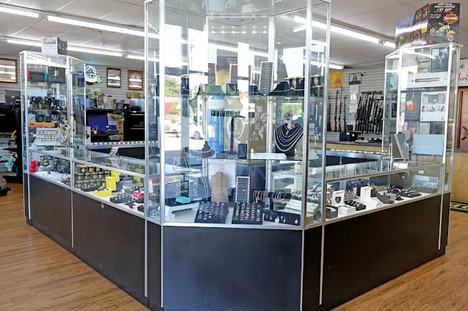 Lit glass jewelry showcases in the middle of The Money Vault showroom